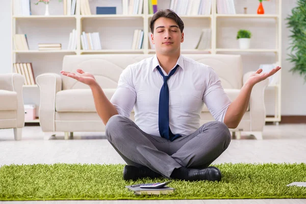 Businessman sitting on the floor in office — Stock Photo, Image