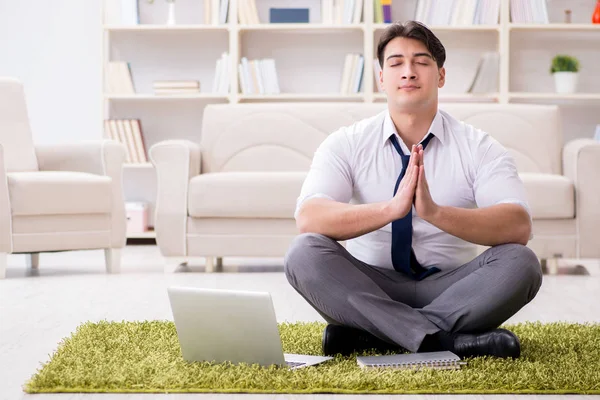 Businessman sitting on the floor in office — Stock Photo, Image