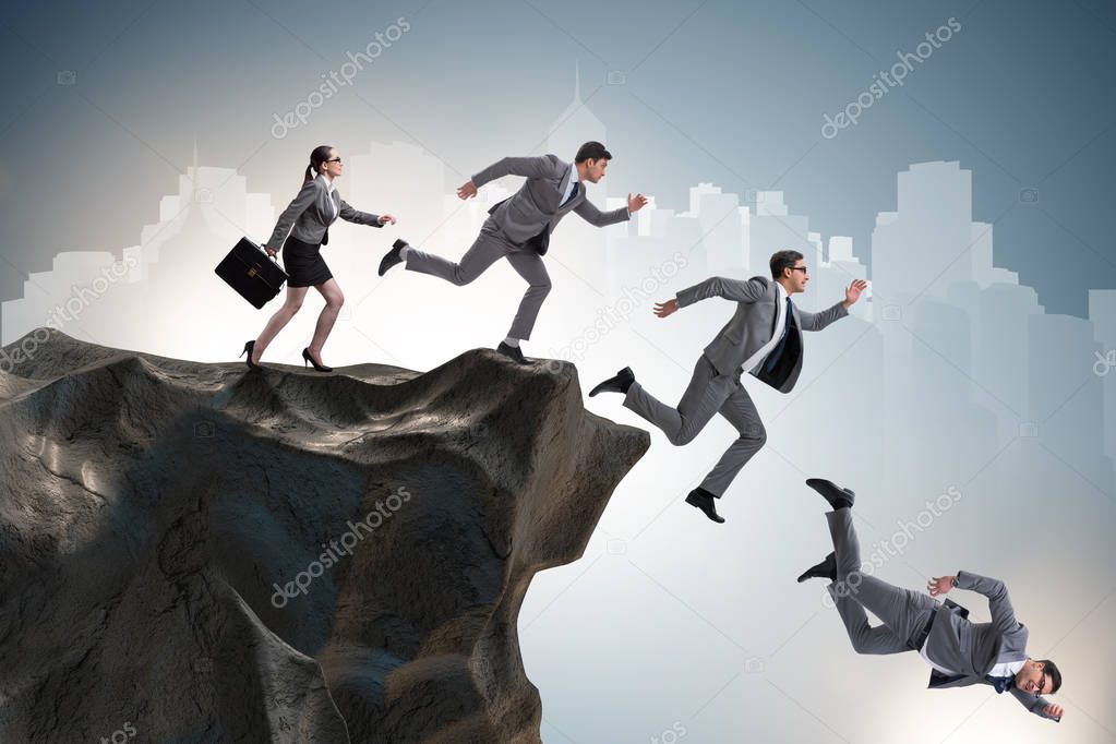 Business people falling off the cliff