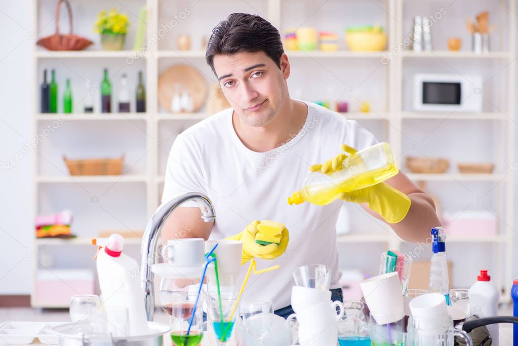Man frustrated at having to wash dishes