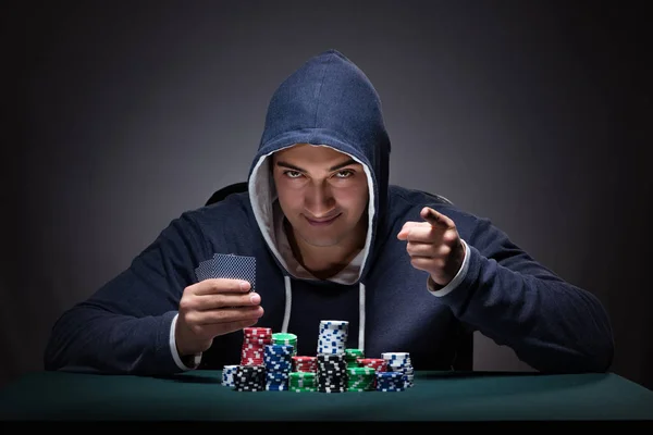 Young man wearing a hoodie with cards and chips gambling — Stock Photo, Image