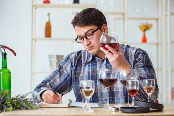 Professional sommelier tasting red wine