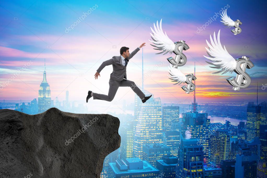 Businessman chasing angel dollars in business concept