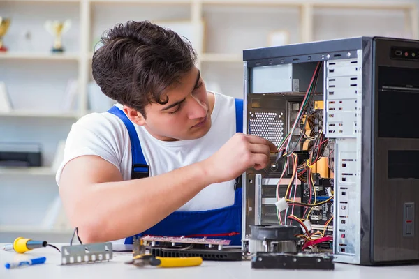 Computer repairman repairing desktop computer