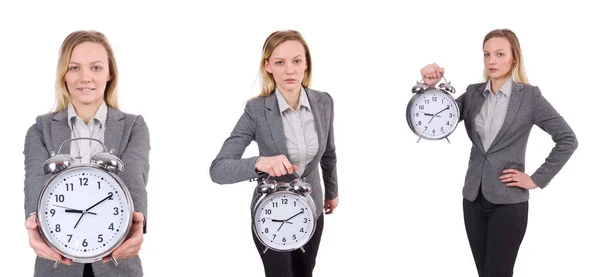 Mujer de negocios en traje gris con reloj despertador aislado en blanco — Foto de Stock