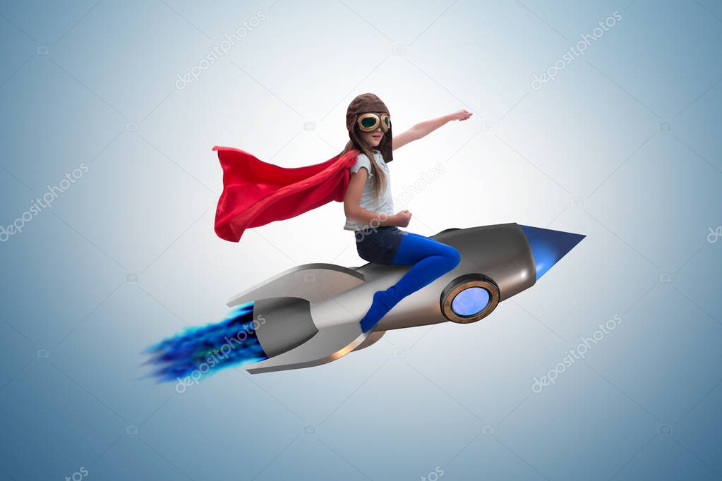 Little girl flying rocket in superhero concept