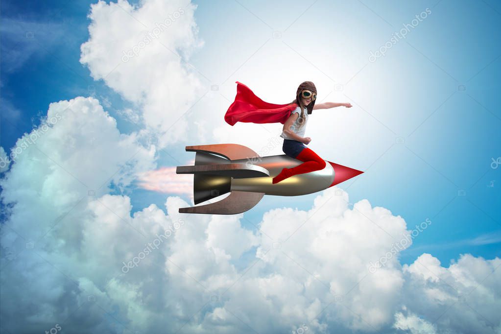 Little girl flying rocket in superhero concept