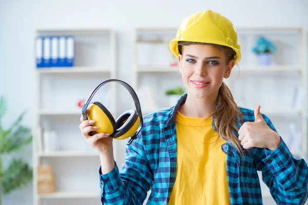 Mujer en taller con auriculares de cancelación de ruido — Foto de Stock