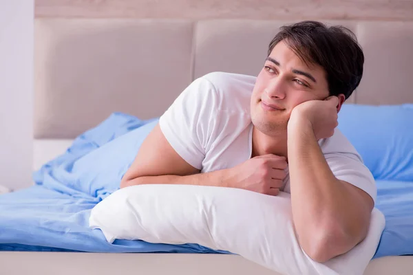 Man suffering from insomnia lying in bed — Stock Photo, Image