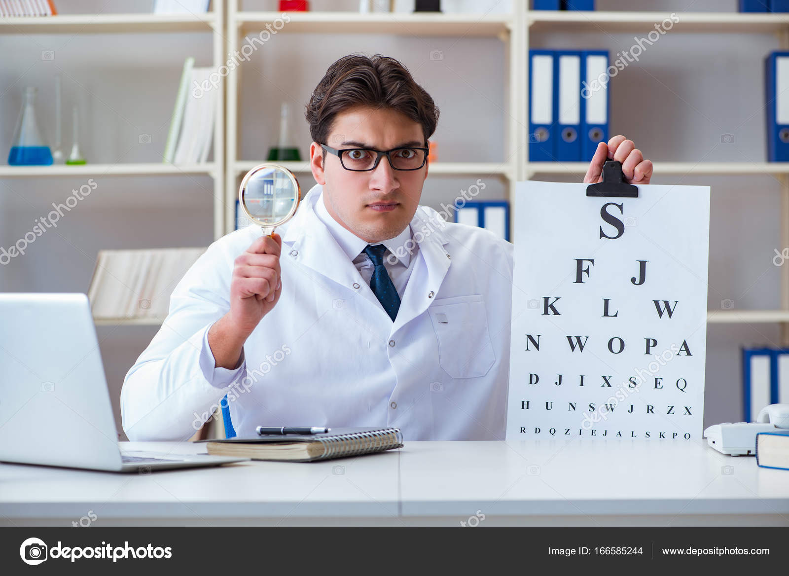 Doctor Optician With Letter Chart Conducting An Eye Test Check