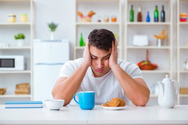 Fazla mesai sonrası kahvaltıda uyuyan bir adam.