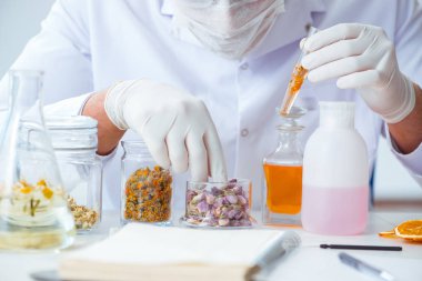 Laboratuvarda parfüm karıştıran bir kimyager.