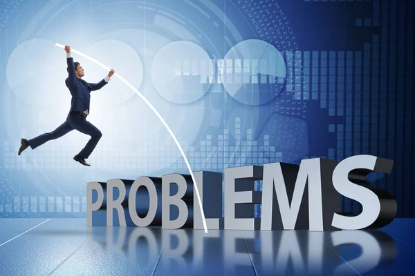 Businessman jumping over problems in business concept — Stock Photo, Image