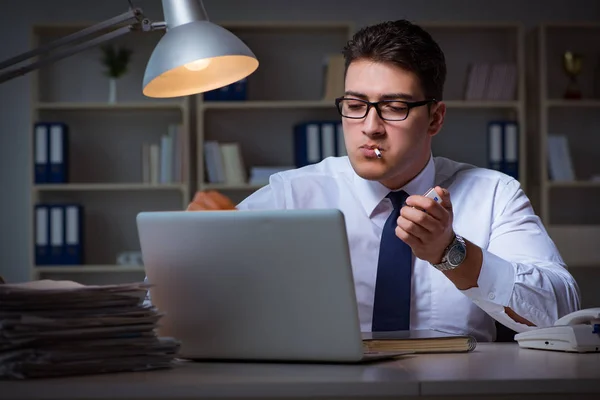 Businessman under stress smoking in office — Stock Photo, Image