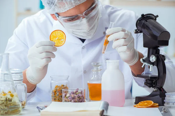 Chemist mixing perfumes in the lab