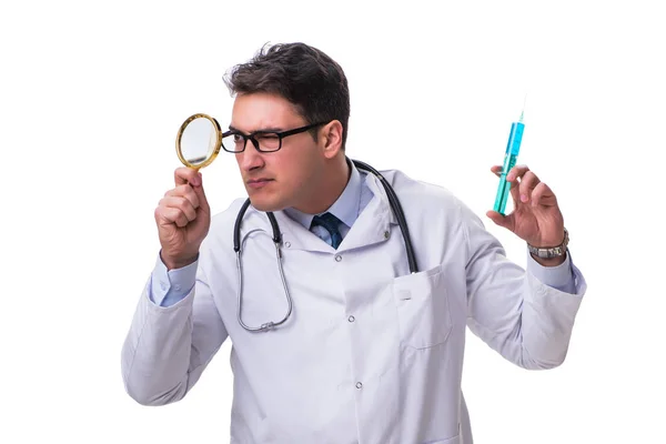 Young doctor with a magnifying glass and a syringe isolated on w — Stock Photo, Image