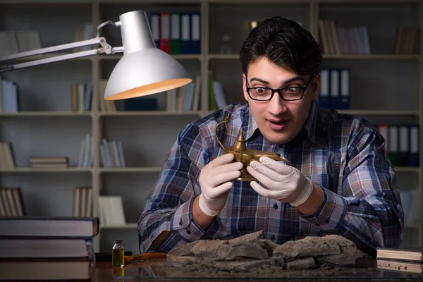 Archeologist working late night in office — Stock Photo, Image