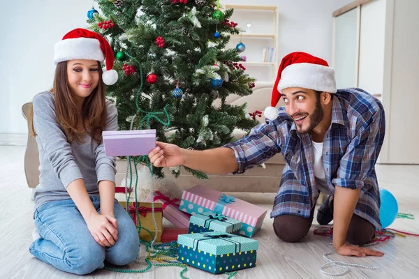 Girlfriend and boyfriend opening christmas gifts