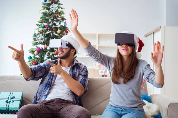 Happy family using virtual reality VR glasses during christmas