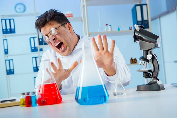Смешной сумасшедший химик, работающий в лаборатории — стоковое фото
