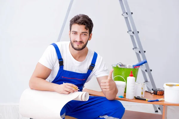 Reparador haciendo reparación de renovación en la casa con wallpa de papel —  Fotos de Stock