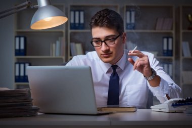 Stres altındaki iş adamı ofiste sigara içiyor