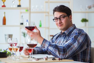 Profesyonel şarap garsonu kırmızı şarap tadıyor.