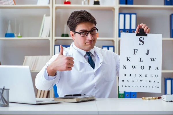 Médecin opticien avec carte postale effectuant un test oculaire — Photo