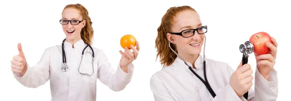 Pretty female doctor with stethoscope and orange isolated on whi — Stock Photo, Image