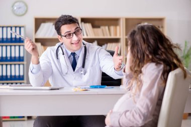 Hamile kadın muayene için doktoru ziyaret ediyor.