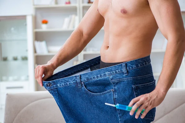 Man in oversized pants in weight loss concept — Stock Photo, Image