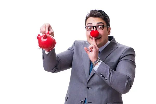 Businessman funny with red nose holding a piggy bank isolated on — ストック写真