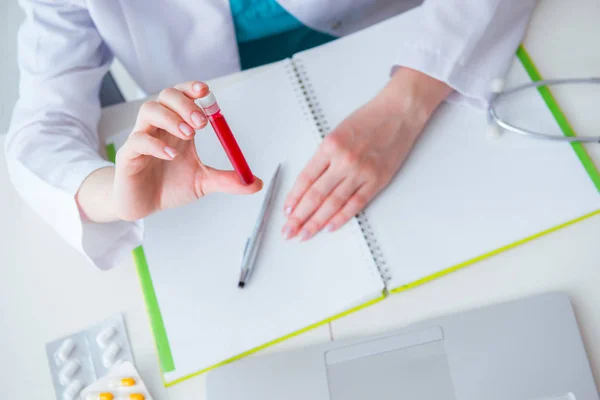 Médico estudiando tubo de sangre en concepto médico —  Fotos de Stock