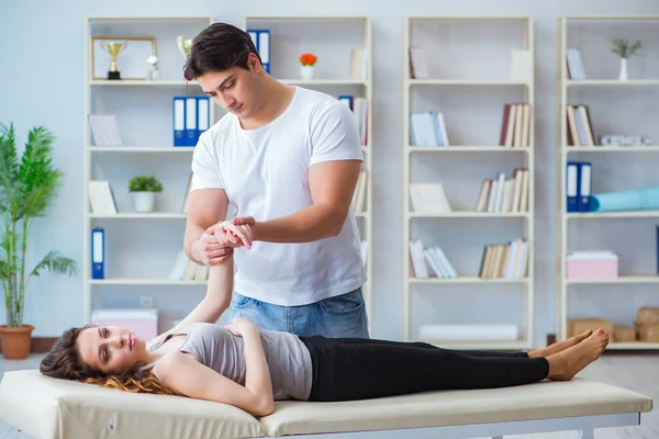 Young doctor chiropractor massaging female patient woman — Stock Photo, Image