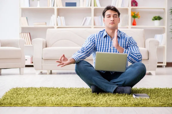 Young handsome man sitting on floor at home — Stock Photo, Image