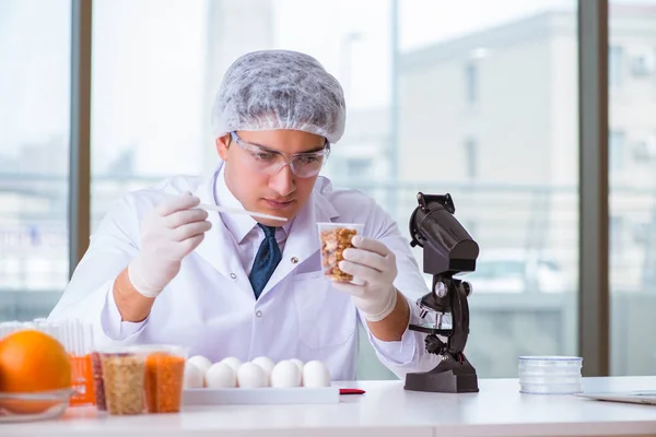 Nutrition expert testing food products in lab Royalty Free Stock Photos