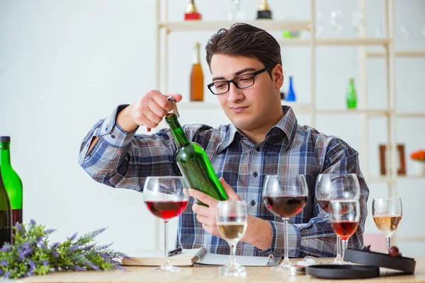 Professional sommelier tasting red wine