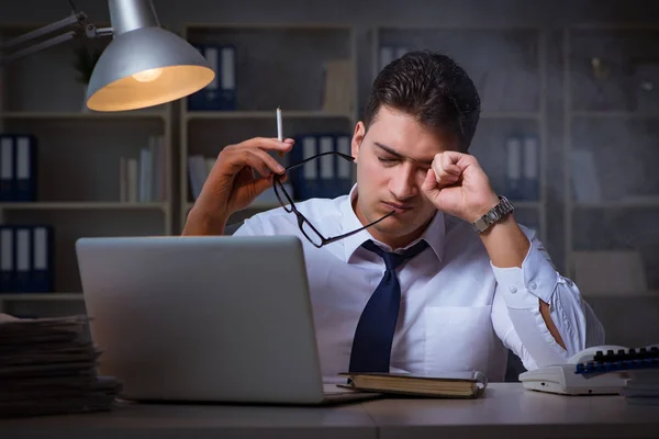 Businessman under stress smoking in office