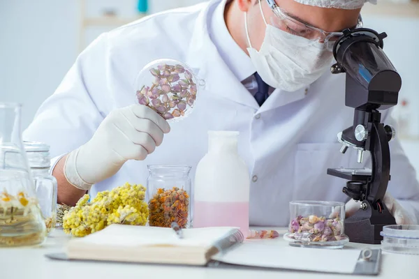 Chemist mixing perfumes in the lab