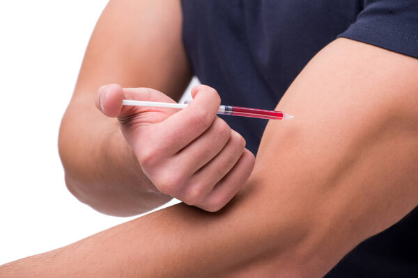 Young man in doping concept isolated on white