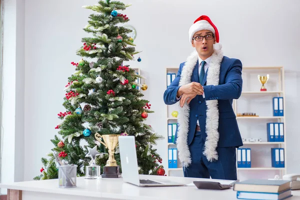 Businessman celebrating christmas holiday in the office