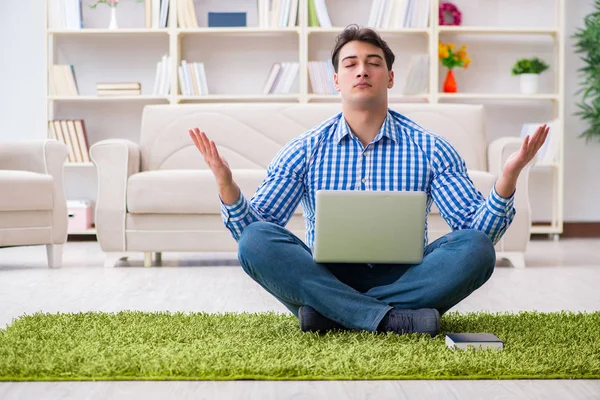 Young handsome man sitting on floor at home — Stock Photo, Image