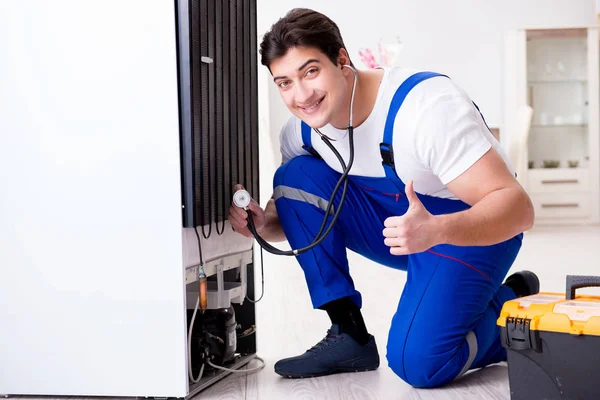 Repairman contractor repairing fridge in DIY concept