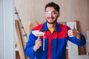 Yooung marangoz boyayla uğraşıyor.