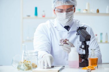 Laboratuvarda parfüm karıştıran bir kimyager.