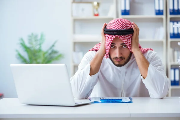 Arab businessman working in the office doing paperwork with a pi Royalty Free Stock Photos
