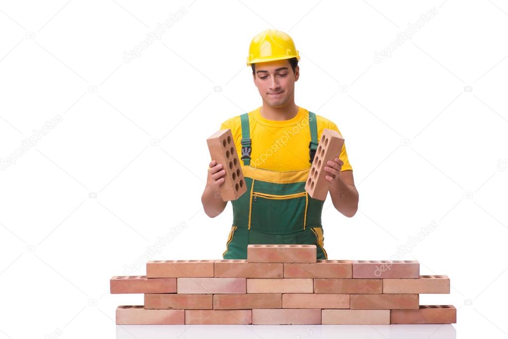 The handsome construction worker building brick wall