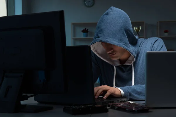 Hacker hacking computer at night