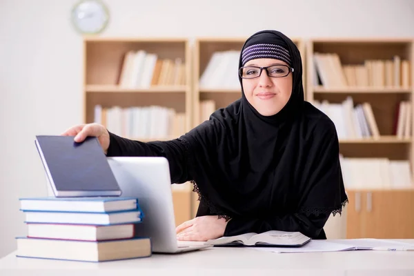 Muslim girl in hijab studying preparing for exams