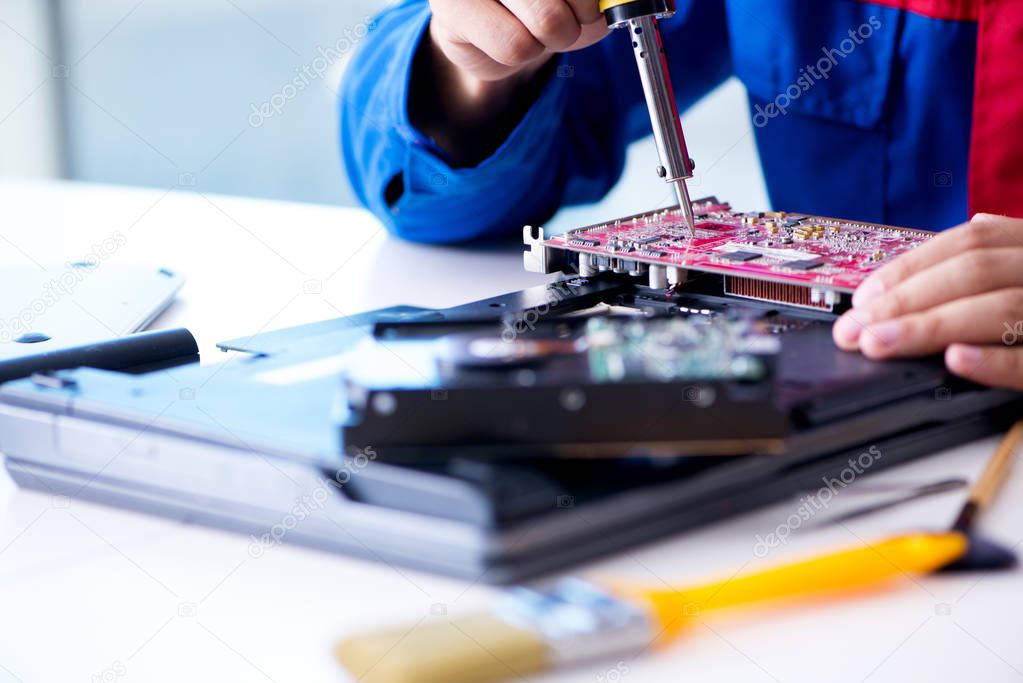 Repairman working in technical support fixing computer laptop tr
